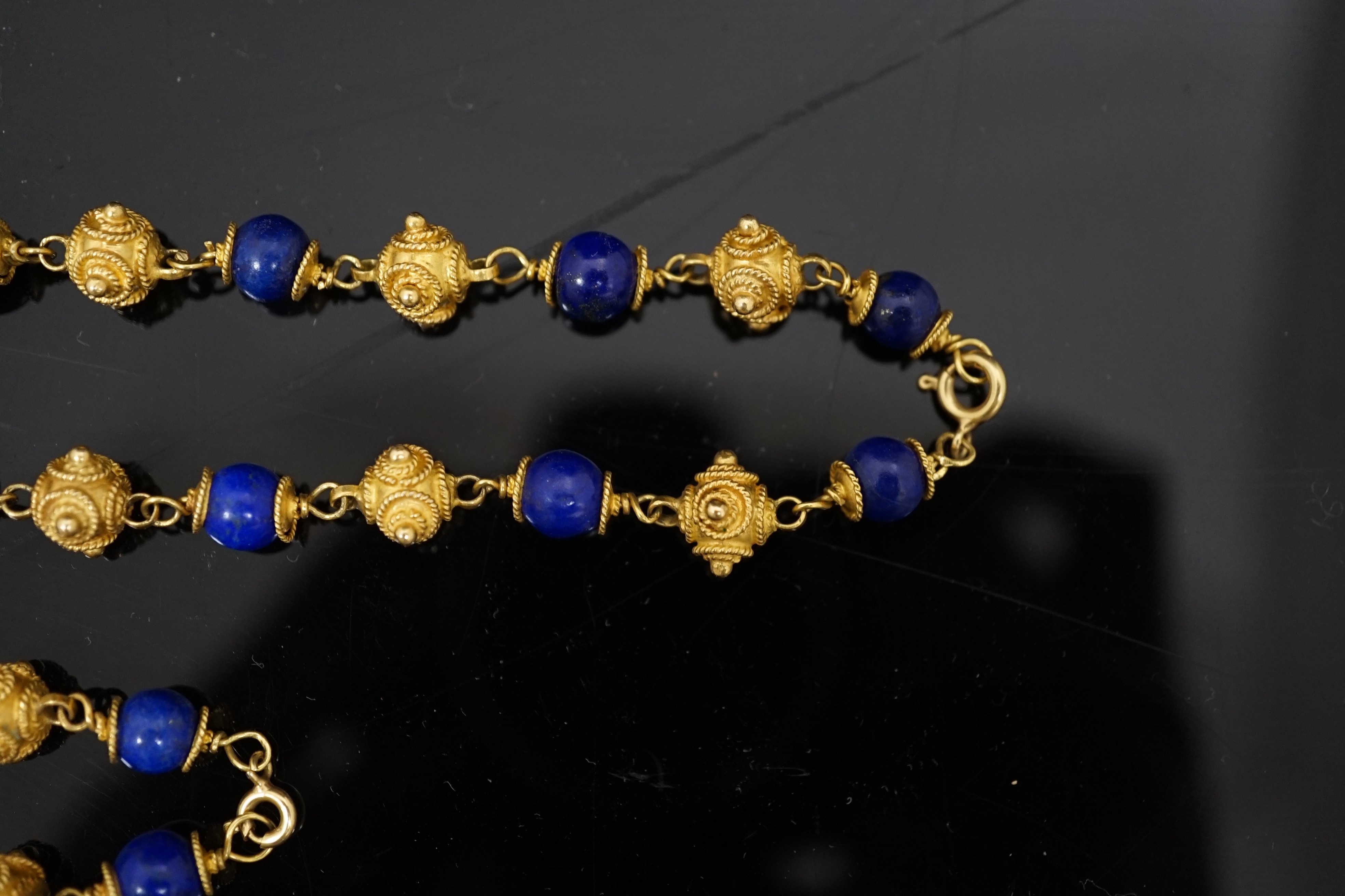 A 20th century Middle Eastern high carat gold canetile work bead and lapis lazuli bead set necklace and matching bracelet